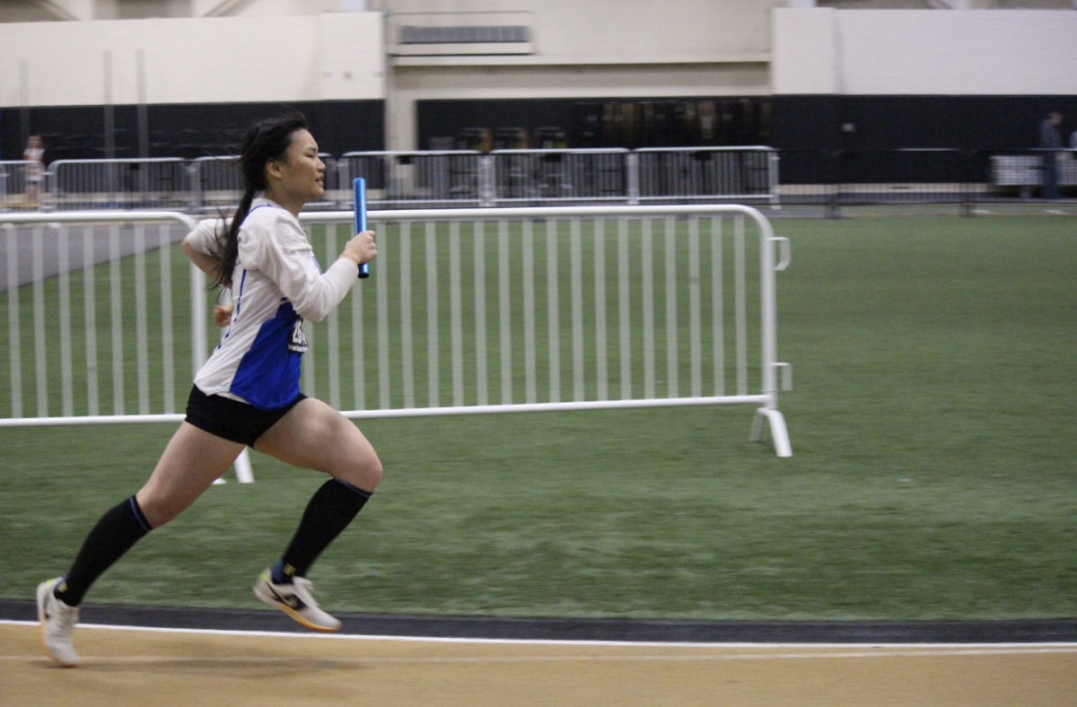 Sophomore Sharon Xiao is recognized during the winter pep rally for her record-breaking 15' 1.75" jump at conference championships.